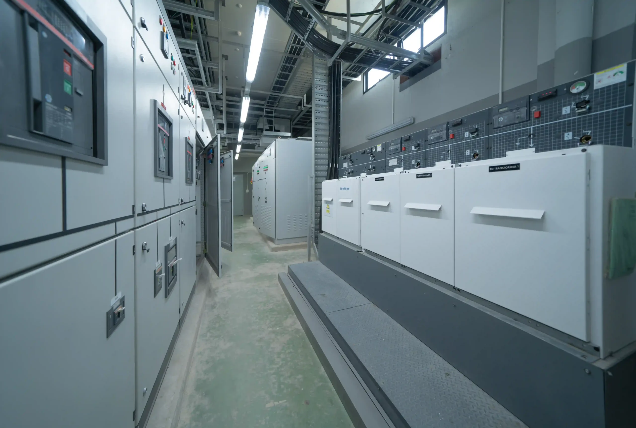 Industrial electrical control room with power distribution panels and equipment